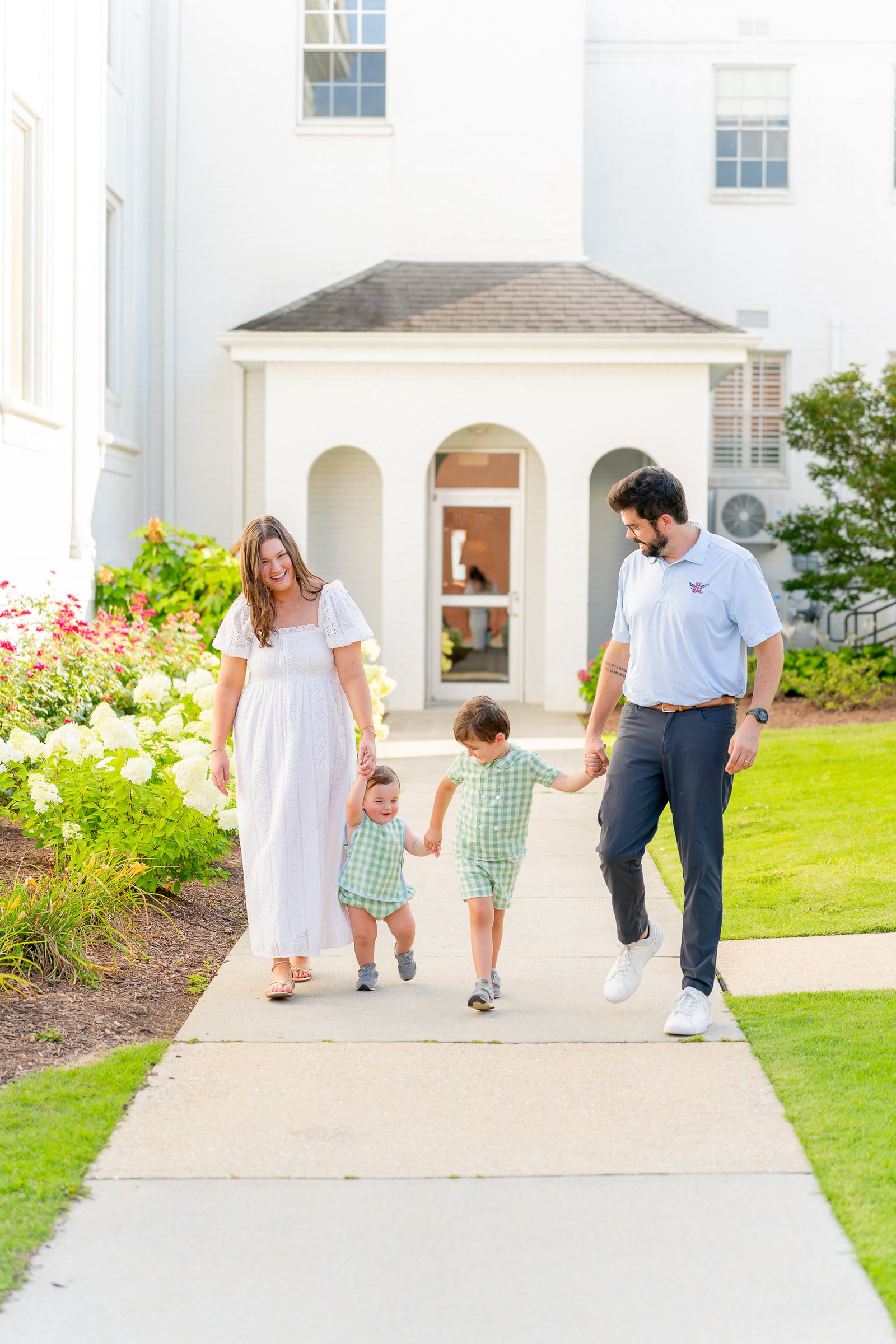 Two little boys running with their parents